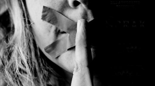 photo of woman with tape on her mouth