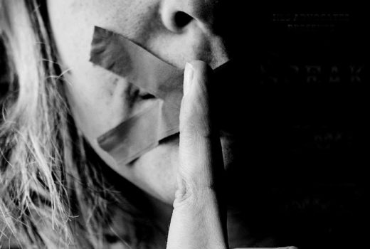 photo of woman with tape on her mouth